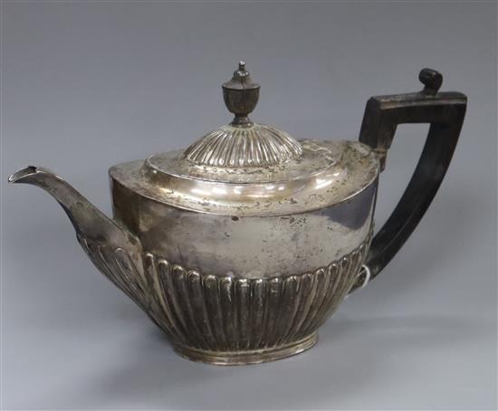A late Victorian demi fluted silver teapot, Sheffield, 1897, gross 12 oz.